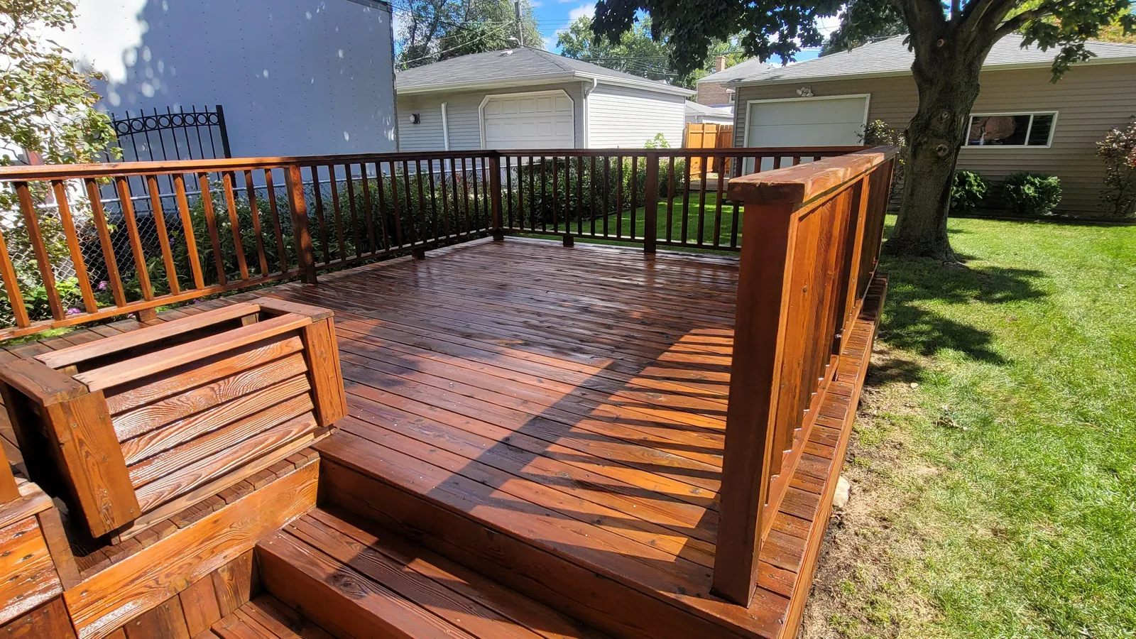 A backyard deck freshly cleaned and stained by Lara's Power Wash LLC